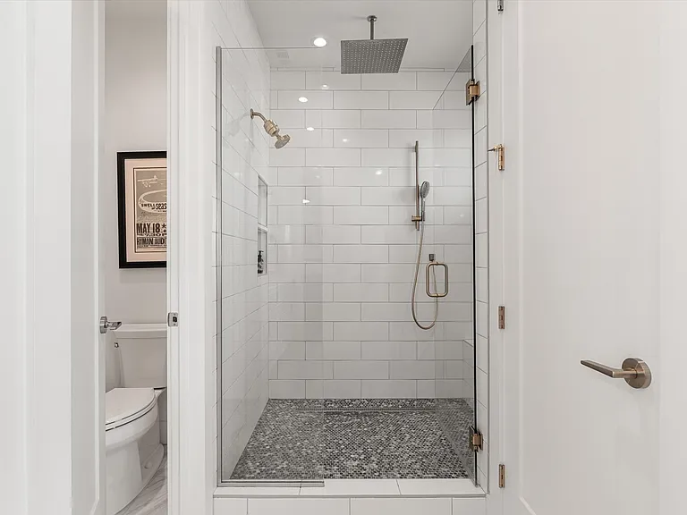 Primary bath featuring dual vanity and contemporary finishes.