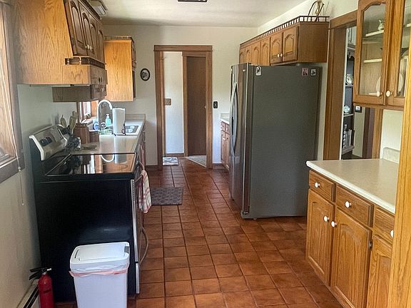 The large kitchen with dishwasher, Stove, refrigerator, microwave, coffeemaker and cupboards full of dishes and pots and pans for your convenience.