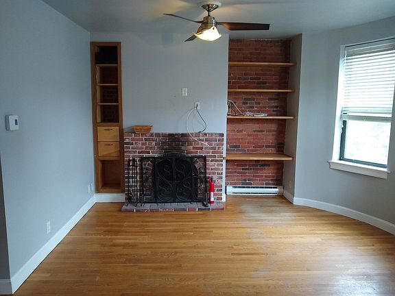 Sunny east facing living room with built-ins