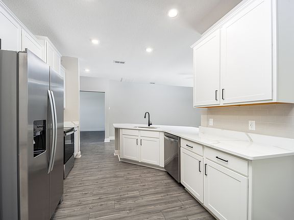 Enjoy beautiful quartz countertops and wood cabinetry!