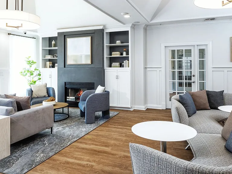 eaves Wilmington West resident lounge with fireplace and seating areas