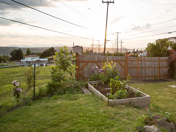 16ft raised garden bed and large fence doors that open to a field.