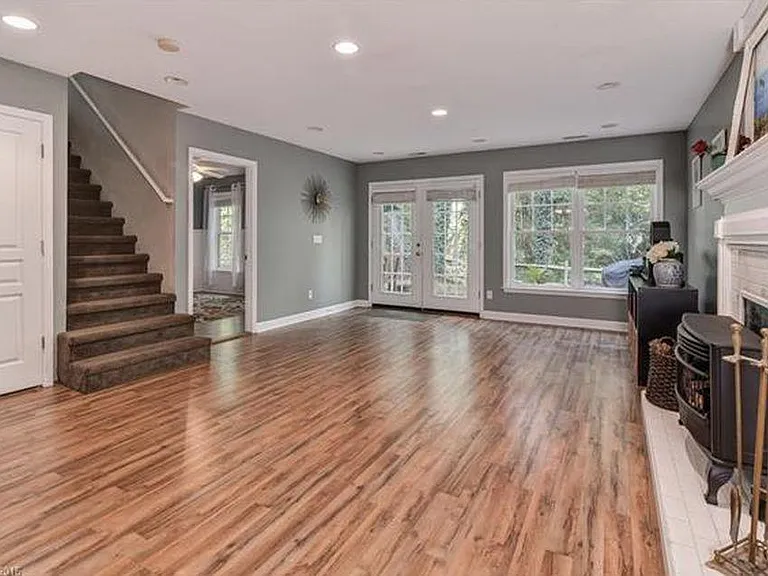 Downstairs has a sizable open room for play, exercise, entertainment, etc., with a gas fireplace and double French doors opening to the back patio.