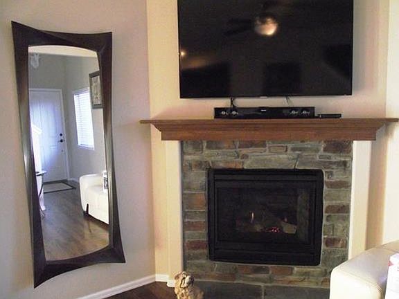 Beautiful stone accented gas fireplace in the living room makes