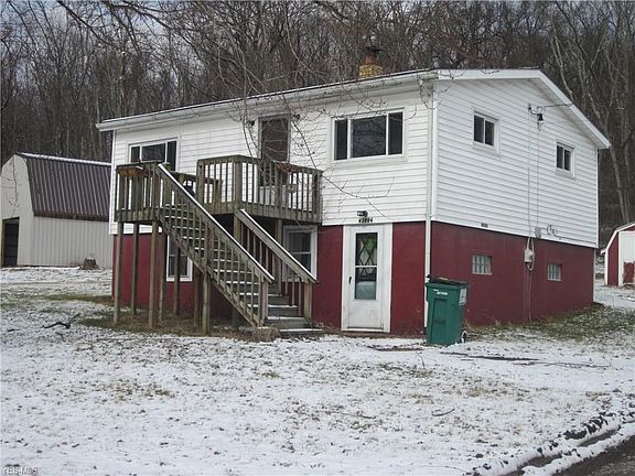 Front of home with high loft barn in corner