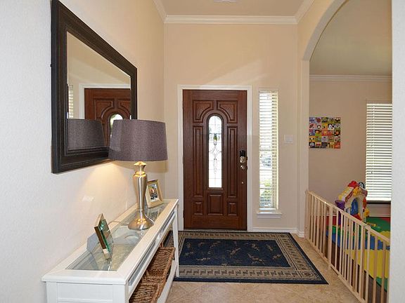 Ceramic tile entry with the formal dining room pictured on the right....having just been built in 2011 there are several upgrades including the front door key-less entry lock.