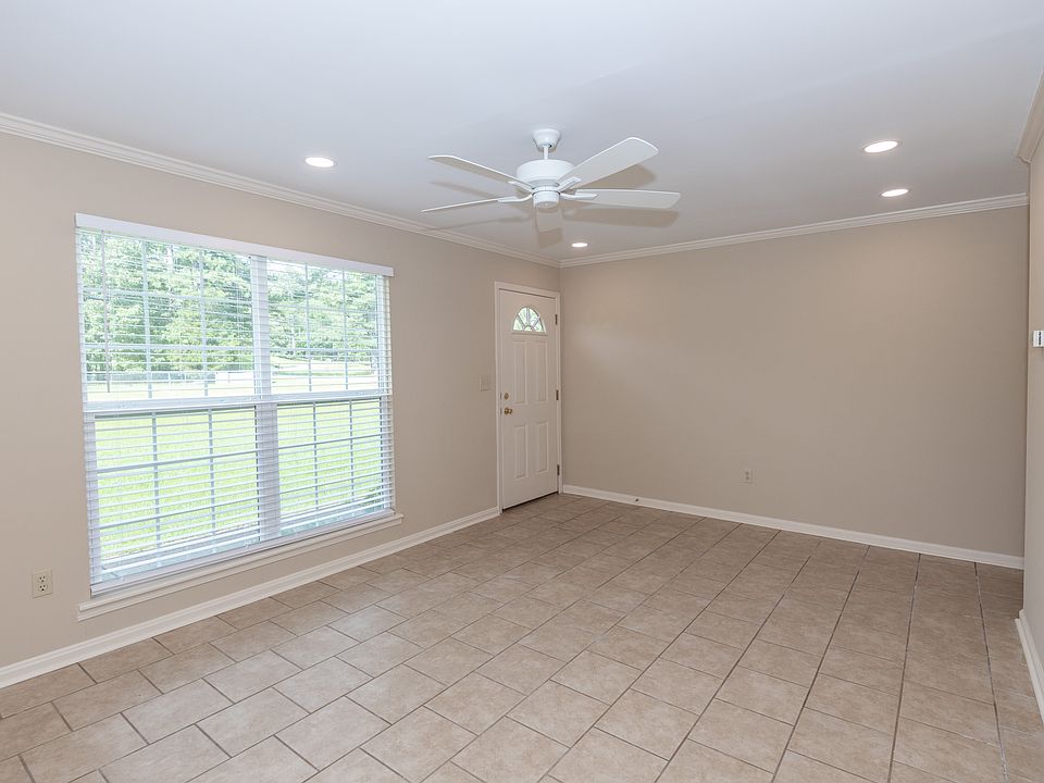 Large living room with ceiling fan, recessed lighting and lots of natural light.