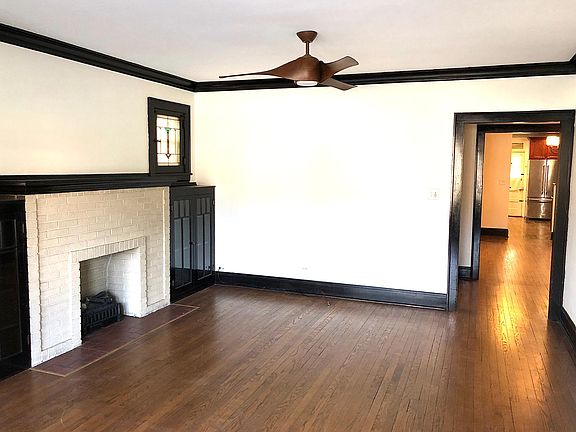 Living room, with original stained glass windows and fireplace.