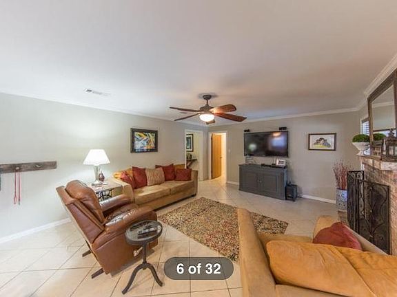 Living room with shot of entryway and hallway