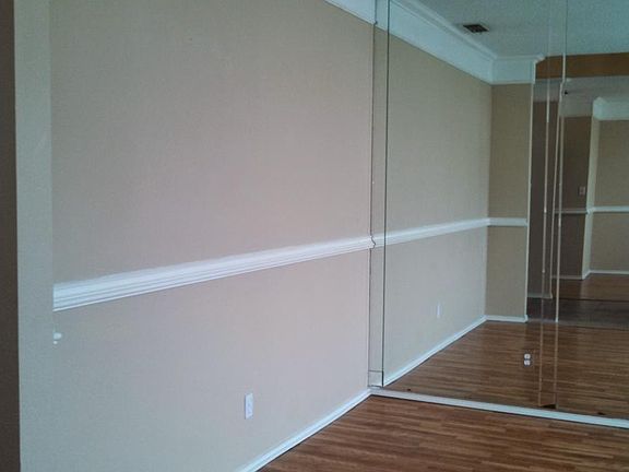 Formal Living Room with wall-to-wall mirror.