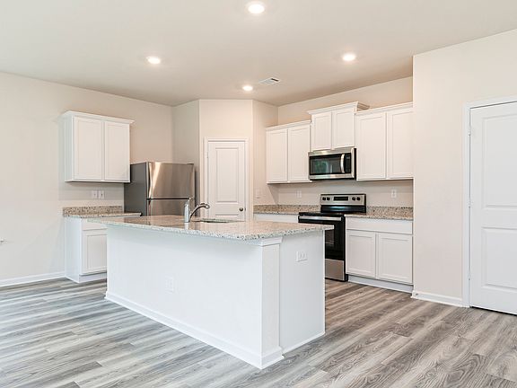 This kitchen is chef-ready with ample space and stainless steel appliances
