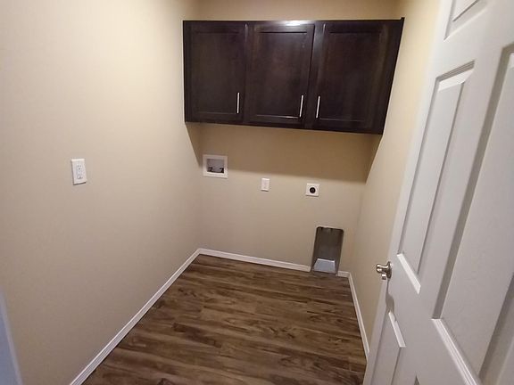 Nicely sized laundry room with cabinets!