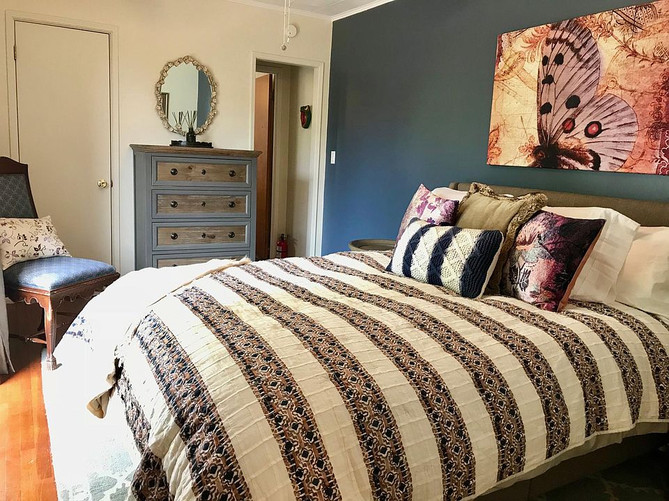 Comfortable bedding. View of private patio.