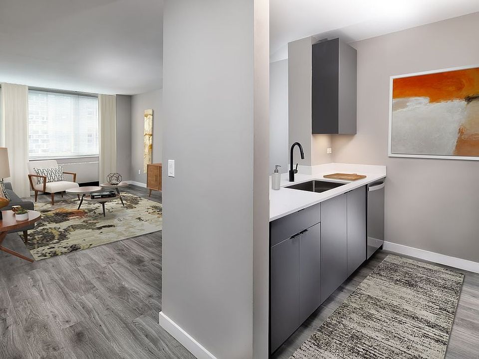 Renovated Package II kitchen, living, and dining areas with hard surface plank flooring