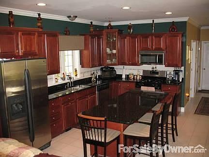 Kitchen
						:
						Cherry cabinets, granite counters, ceramic floor, crown molding, 9 ft ceiling