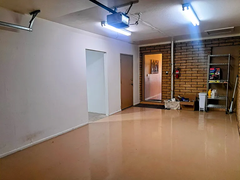 One side of garage interior. Other garage bay is through the open doorway