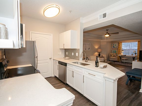 Gourmet Kitchens w White Cabinetry Quartz Counters w Glasstile Backsplash Stainless Steel Appliances Plank Flooring LED Lighting and Ceiling Fans Washer Dryer in Every Home Brushednickel Finishes 2inch Plantation Blinds Outlets with USB Ports 9foot Ceili