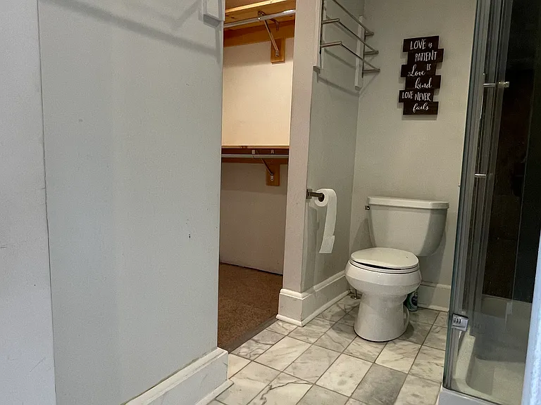 Private full bathroom off the primary bedroom, with access to the walk-in closet.