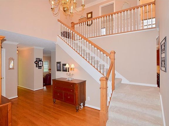 2-story entry with hardwood floor, crown molding and dual staircase.