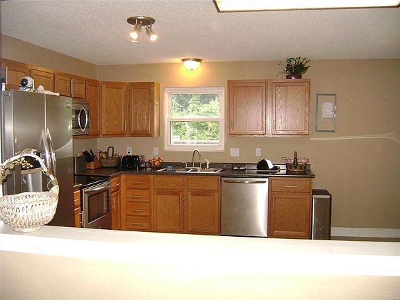 Looking through large opening from living room to kitchen