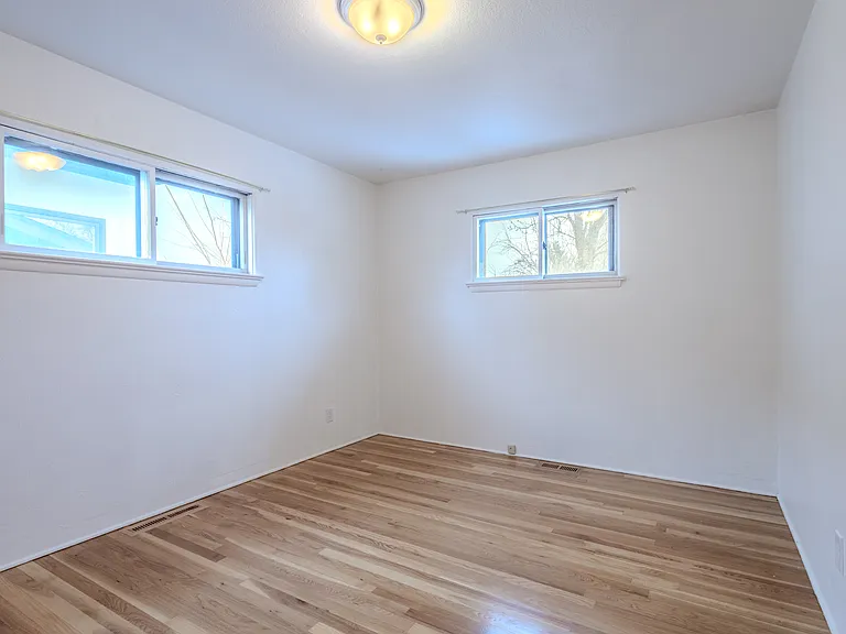 Second upstairs bedroom looks toward the private back yard. Private, spacious, great closet.