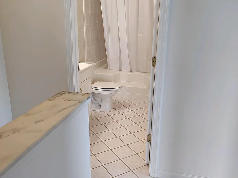 Upstairs hallway to master bathroom and large luxurious garden tub.