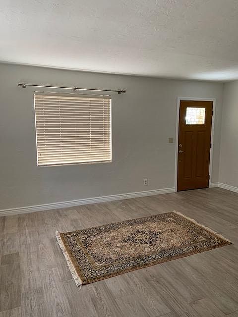 Aah, the living room. New stainless steel drapery rods await your choice of draperies. The soft, driftwood floor await your rug and furniture. Note the nice new white baseboards.