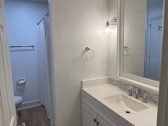 Upstairs full bathroom with tile floor and extra large vanity top.