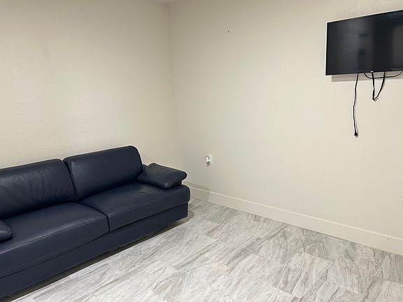 Comfortable living room with TV, ready to relax after work.
