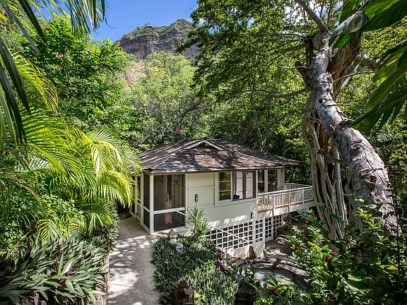 Steps down to the base of Diamond Head, house is surrounded by lush greenery and no neighboring around.