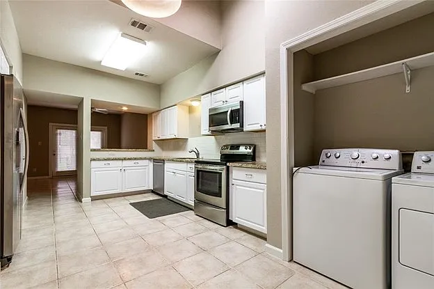 Small laundry area connected to the kitchen.