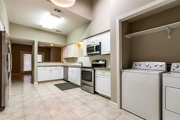 Small laundry area connected to the kitchen.