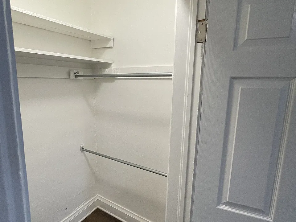 walk-in closet in bedroom with lots of shelving