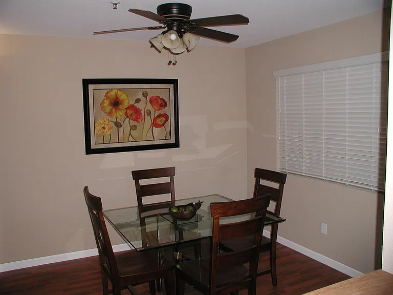 Your dining room open to the living room natural light is also fitted with a sliding window dressed in horizonal blinds, and a fan light. We change out all attached lighting fixture bulbs for you!
