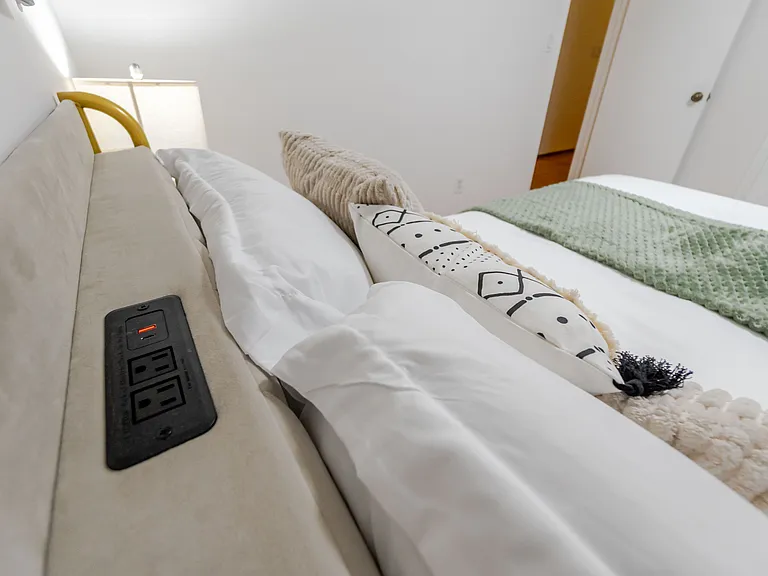 A bedroom featuring an outlet for added convenience and easy access to power.
