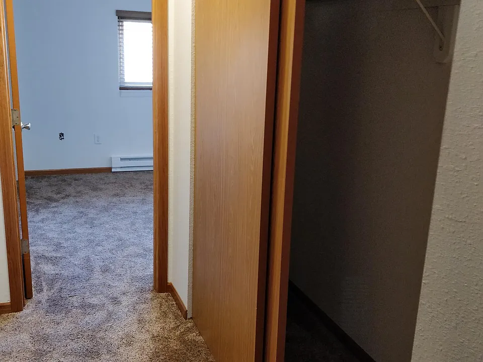 Hallway from living room to bed/bathroom with closet RIGHT.