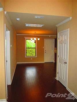 Foyer entrance with hardwood flooring.