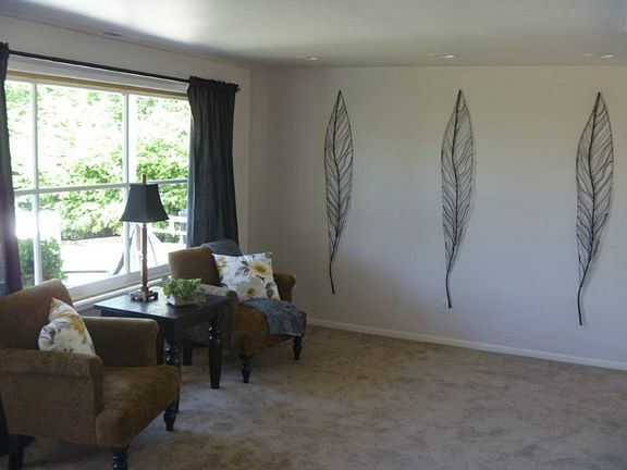 Nice sized living room with huge front window flooding it with natural light.