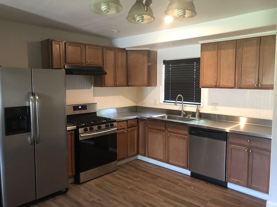Kitchen, gas stove, stainless counter tops.