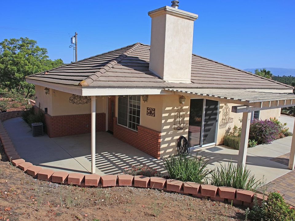 Full view of the house entry and covered patio.