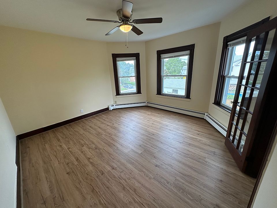 Spacious living area with ceiling fan.
