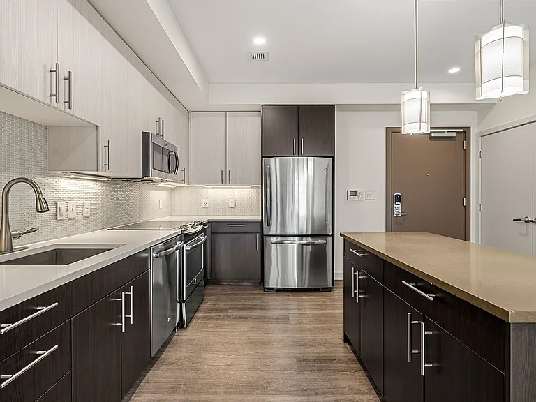Large, modern kitchen with breakfast bar and designer cabinets