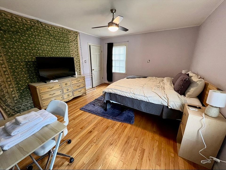 Primary bedroom with queen bed and desk