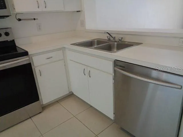 Kitchen has updated granite countertops and tile backsplash since photos were taken