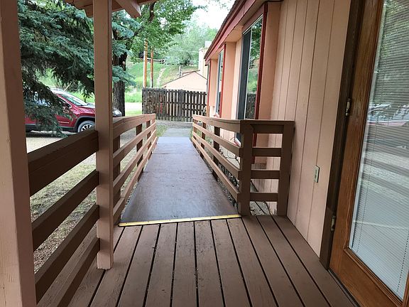 The front entrance has stairs on one side and a ramp on the other