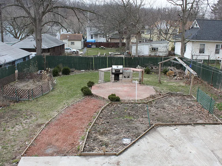 Backyard features built in grill, garden and large patio