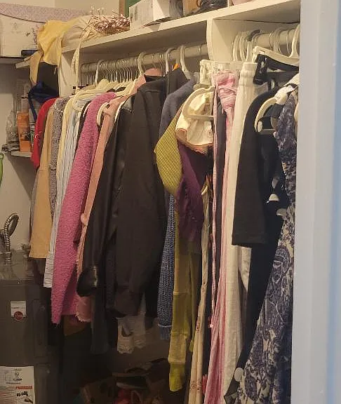 One side of the walk-in closet, other side has shelves.