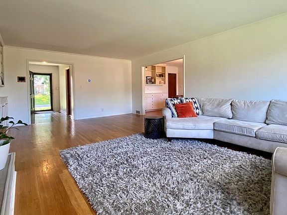 Main living room with abundant natural light year round and wood burning fireplace.