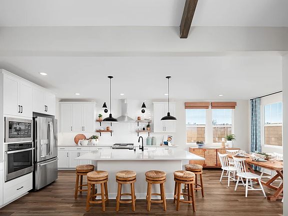 Kitchen with spacious island and sun-lit dining area
