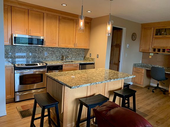 Updated kitchen. Island has side wings that allow for 4 people to sit.